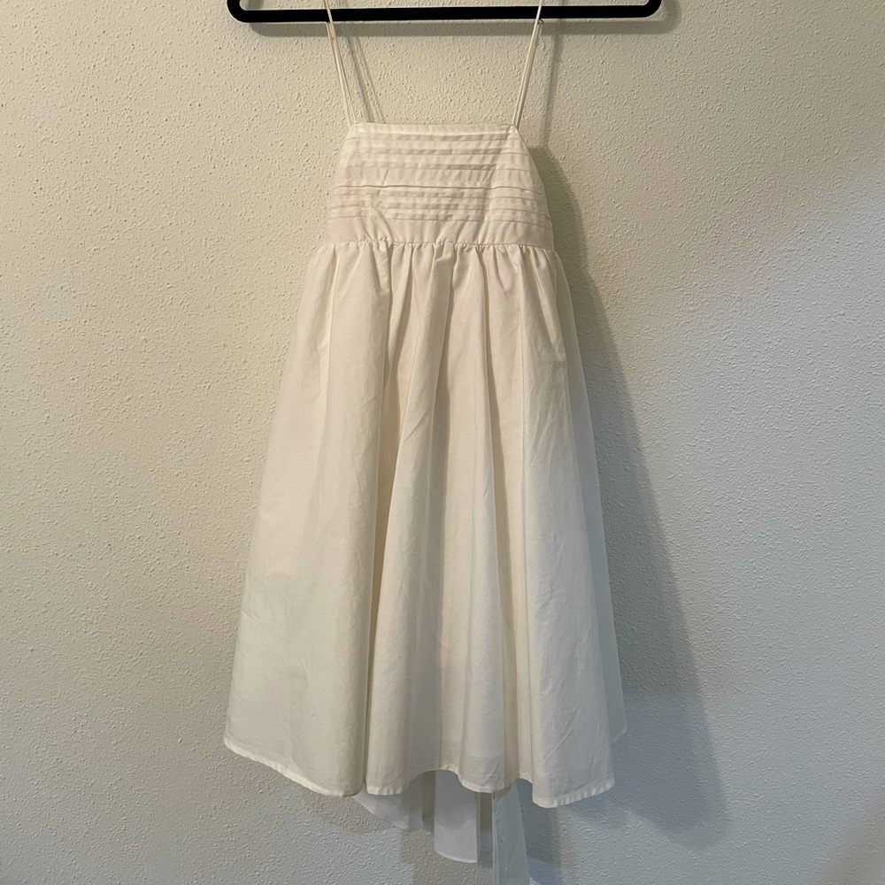 White sundress with pleating and bow